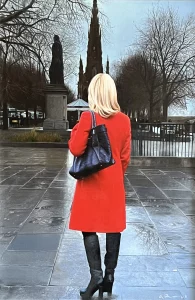 Red coat by the gardens
